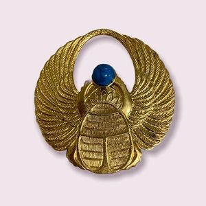 Egyptian gold tone pendant with a turquoise stone